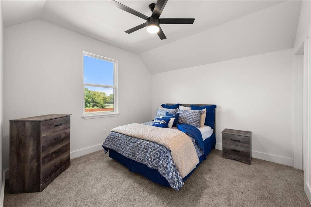 122 Yvonne Street, Red Oak, TX 75154 Vaulted ceiling featuring a matte black finish ceiling fan and neutral wall-to-wall carpeting