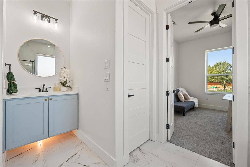 122 Yvonne Street, Red Oak, TX 75154 Mother in law ensuite bathroom with a floating vanity with under cabinet lighting & a quartz countertop.