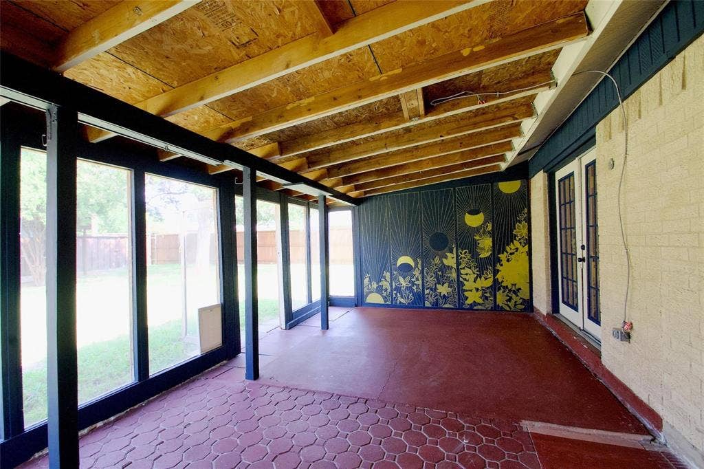 2708 N Avenue, Plano, TX 75074 Enclosed sunroom featuring a covered porch with exposed wood beams, red hexagonal tile flooring, expansive floor-to-ceiling windows, and French doors
