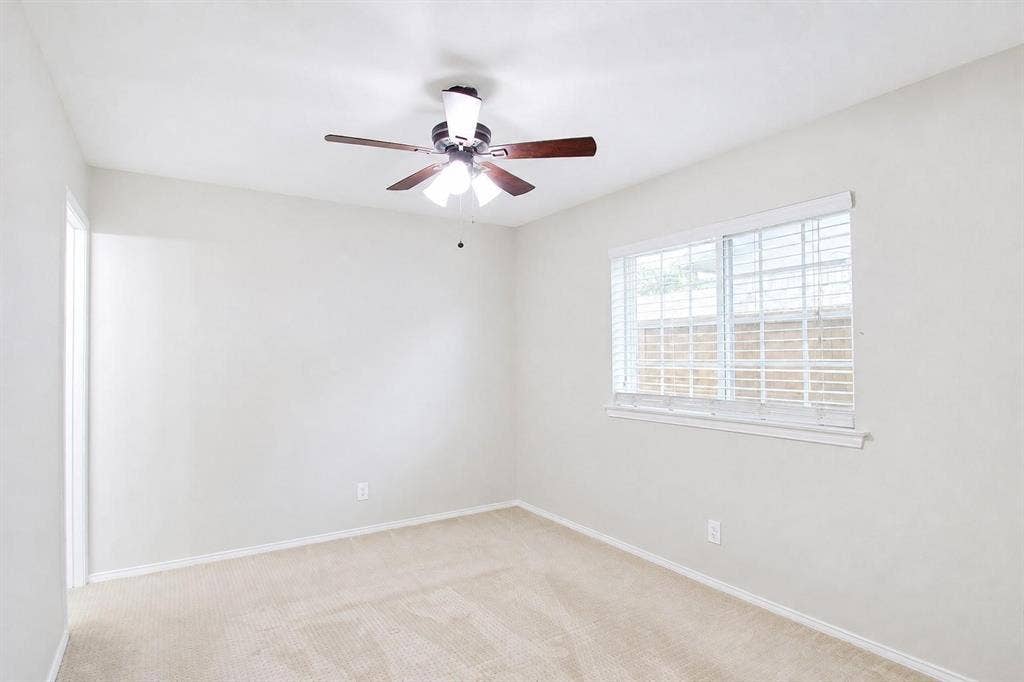 2708 N Avenue, Plano, TX 75074 Neutral-toned carpeted flooring, wall-mounted ceiling fan with integrated lighting, and horizontal window blinds