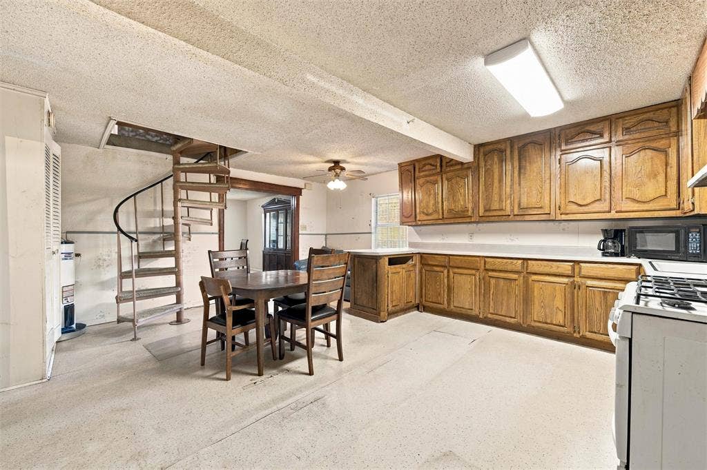 1703 Arra Street, Waco, TX 76704 Kitchen featuring wood cabinetry, integrated gas range, and spiral metal staircase