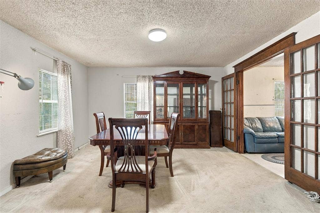 1703 Arra Street, Waco, TX 76704 Interior space featuring built-in wooden cabinetry and French doors with wood-trim detailing