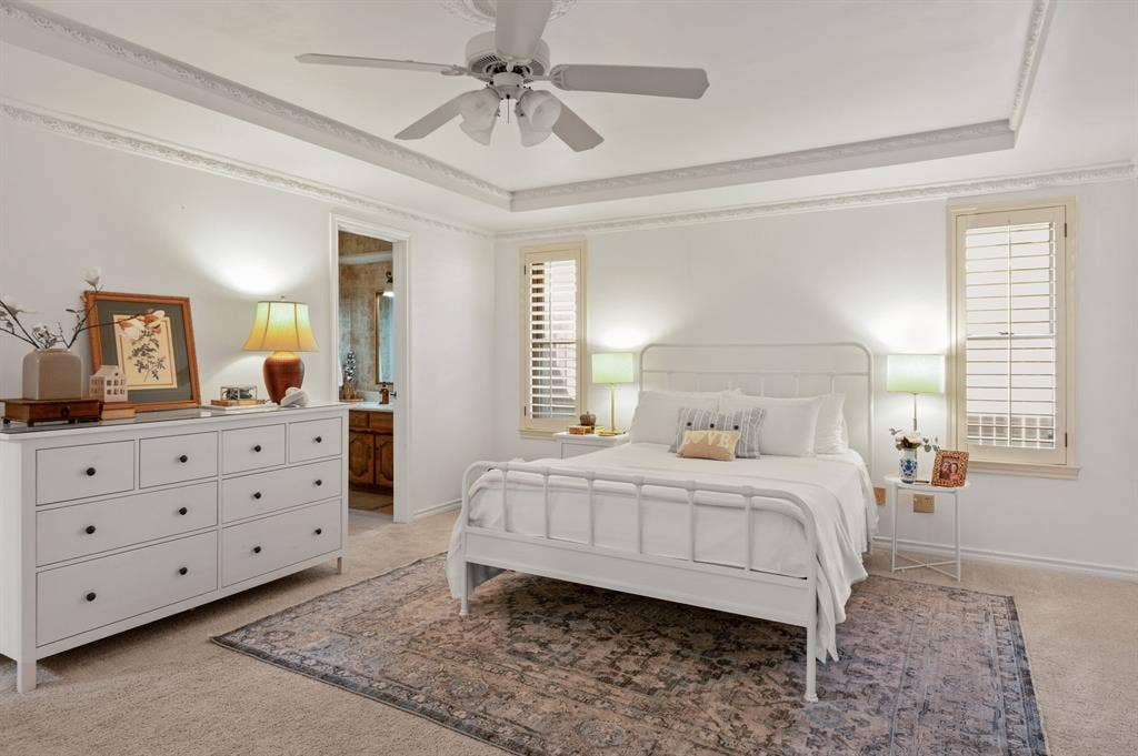 621 Harvest Glen Drive, Richardson, TX 75081 Tray ceiling with intricate crown molding, central ceiling fan, and plantation shutters
