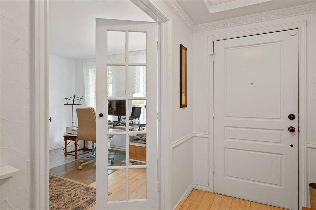 621 Harvest Glen Drive, Richardson, TX 75081 Entryway featuring a white paneled door, crown molding, chair rail trim, and a glass-paneled French door