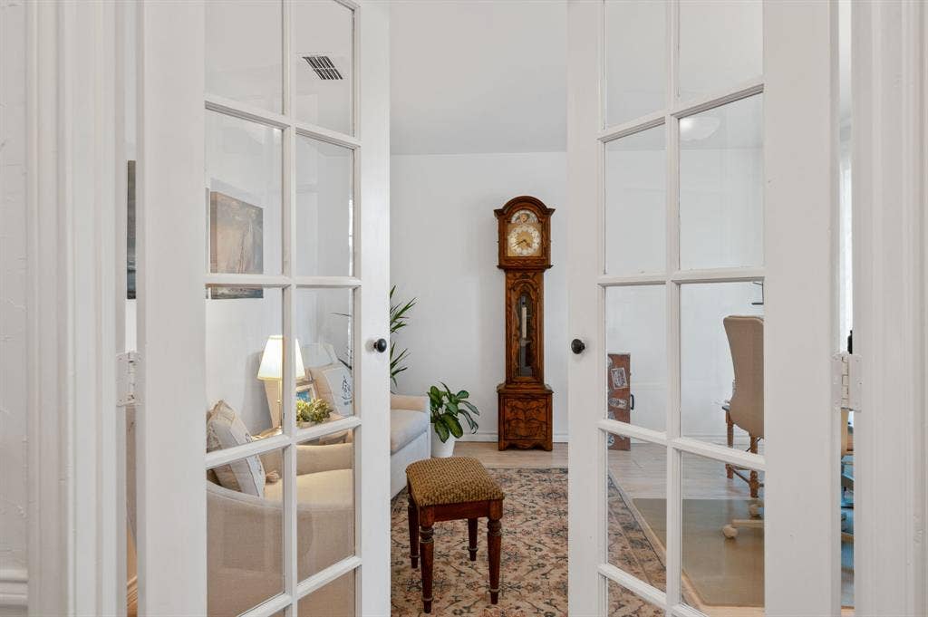 621 Harvest Glen Drive, Richardson, TX 75081 White-framed French doors featuring glass panes and black hardware
