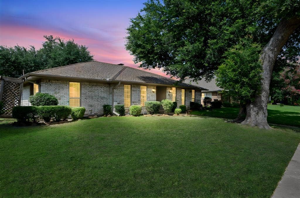 621 Harvest Glen Drive, Richardson, TX 75081 Single-story brick exterior featuring a multi-pitched roofline, mature trees, and manicured landscaping