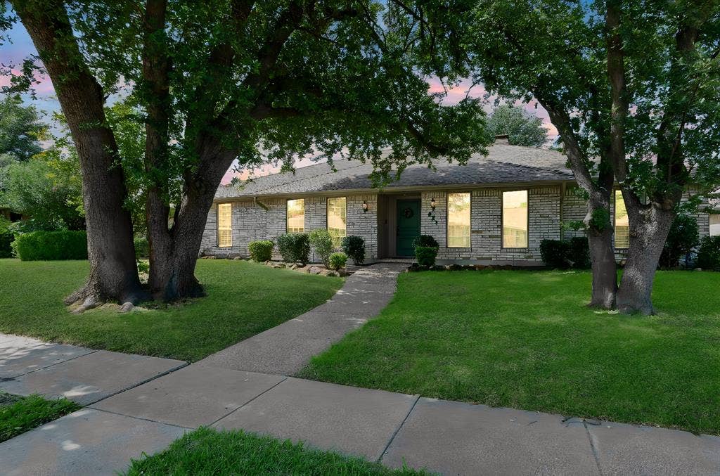 621 Harvest Glen Drive, Richardson, TX 75081 Single-story brick exterior featuring a concrete walkway, gabled roofline, and mature trees on a landscaped lot