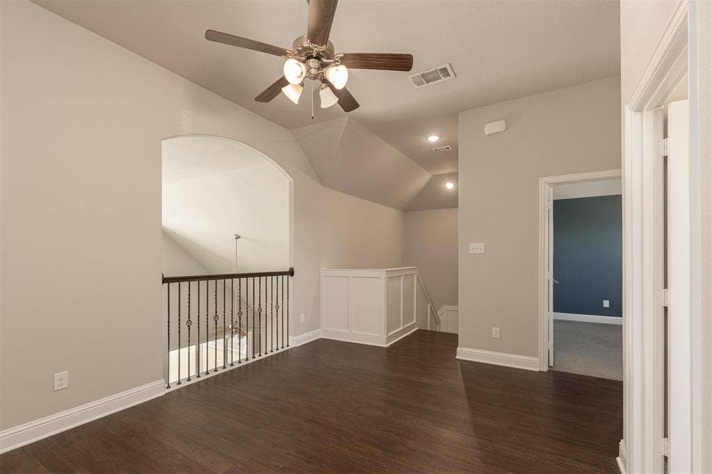 1742 Amalfi Drive, McLendon Chisholm, TX 75032 Wood-finish flooring, vaulted ceiling, metal baluster railing, recessed lighting, and a multi-light ceiling fan