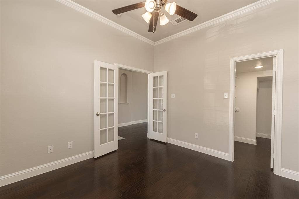 1742 Amalfi Drive, McLendon Chisholm, TX 75032 Room featuring wood-finish flooring, high ceilings with crown molding, double French doors, and a decorative arched wall niche