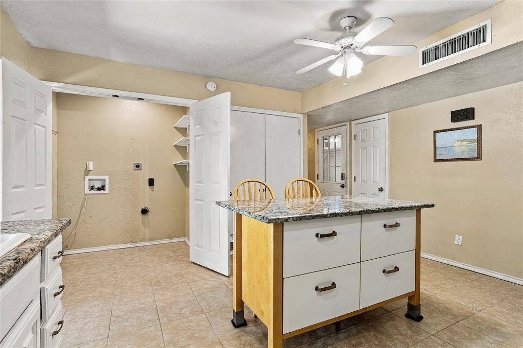1901 Dodge Trail, Grand Prairie, TX 75052 Spacious kitchen with white cabinetry, generous counter space, a center island, and a bright, functional layout.