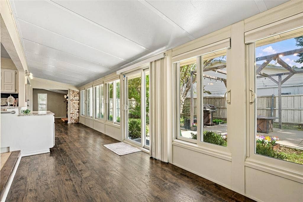 1901 Dodge Trail, Grand Prairie, TX 75052 Additional sunroom view showcasing multiple windows, backyard views, and a light-filled space with flexible use options.