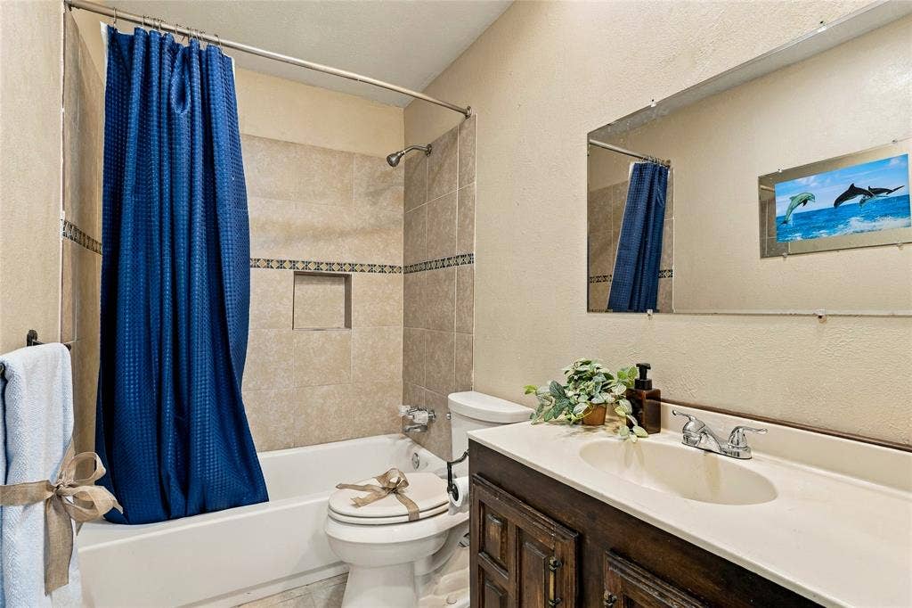 1901 Dodge Trail, Grand Prairie, TX 75052 Full bathroom featuring a bathtub and shower combination, vanity with countertop, and neutral tile finishes.