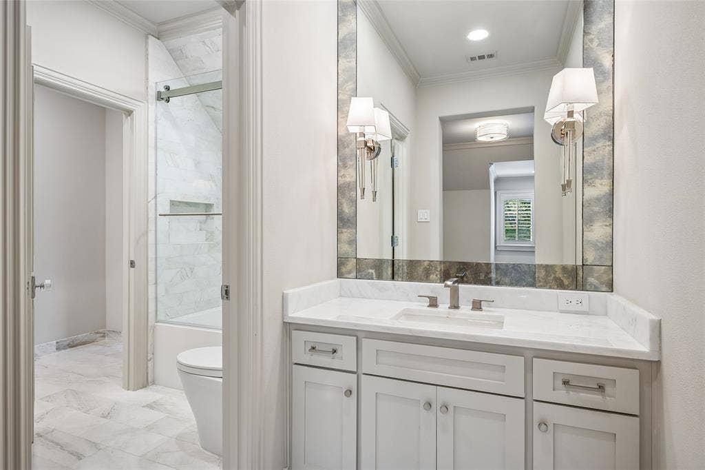Adjoing bath has dressing-vanity areas for each of the two upstairs bedrooms