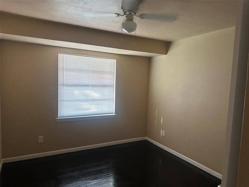 11809 Oberlin Drive, Dallas, TX 75243 Wood-finish flooring, ceiling fan with integrated lighting, and horizontal window blinds