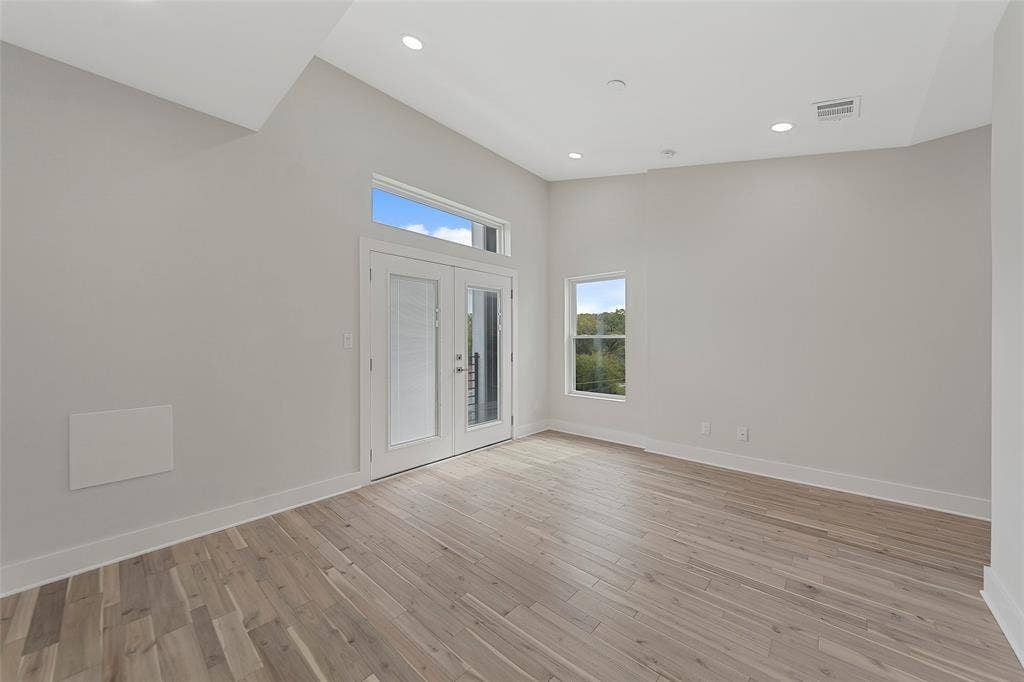 2503 Crossman Avenue, Dallas, TX 75212 Vaulted ceiling with recessed lighting, wood-finish flooring, and double glass-paned doors featuring a transom window