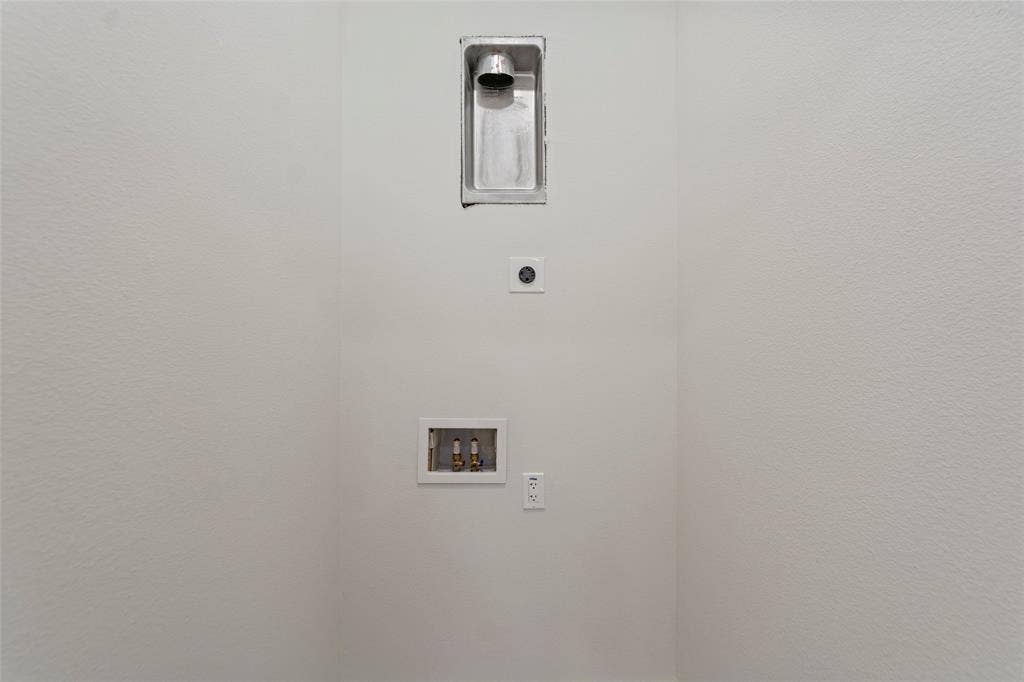 2503 Crossman Avenue, Dallas, TX 75212 Dedicated laundry alcove featuring a recessed dryer vent, plumbing connections for a washing machine, and integrated electrical outlets