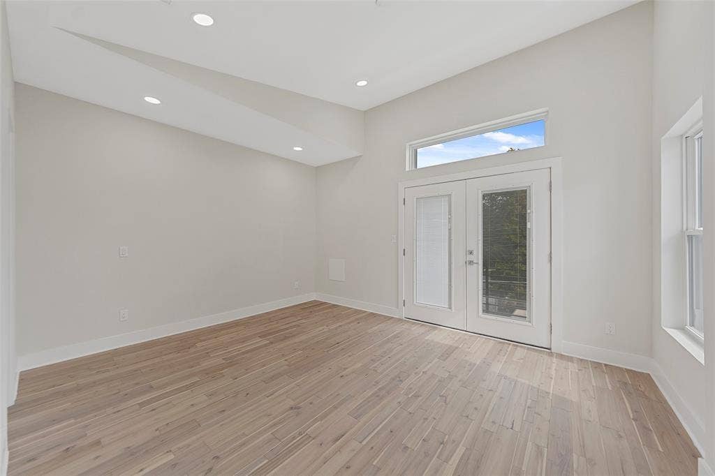 2503 Crossman Avenue, Dallas, TX 75212 Vaulted ceiling featuring recessed lighting, wood-finish flooring, and glass-paneled double doors topped with a rectangular transom window