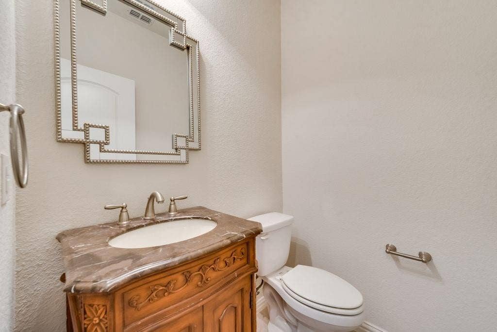 636 S Greenville Avenue, Richardson, TX 75081 Bathroom featuring vanity and toilet