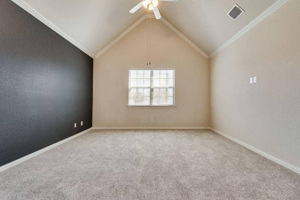 636 S Greenville Avenue, Richardson, TX 75081 Unfurnished room with ceiling fan, light colored carpet, crown molding, and vaulted ceiling