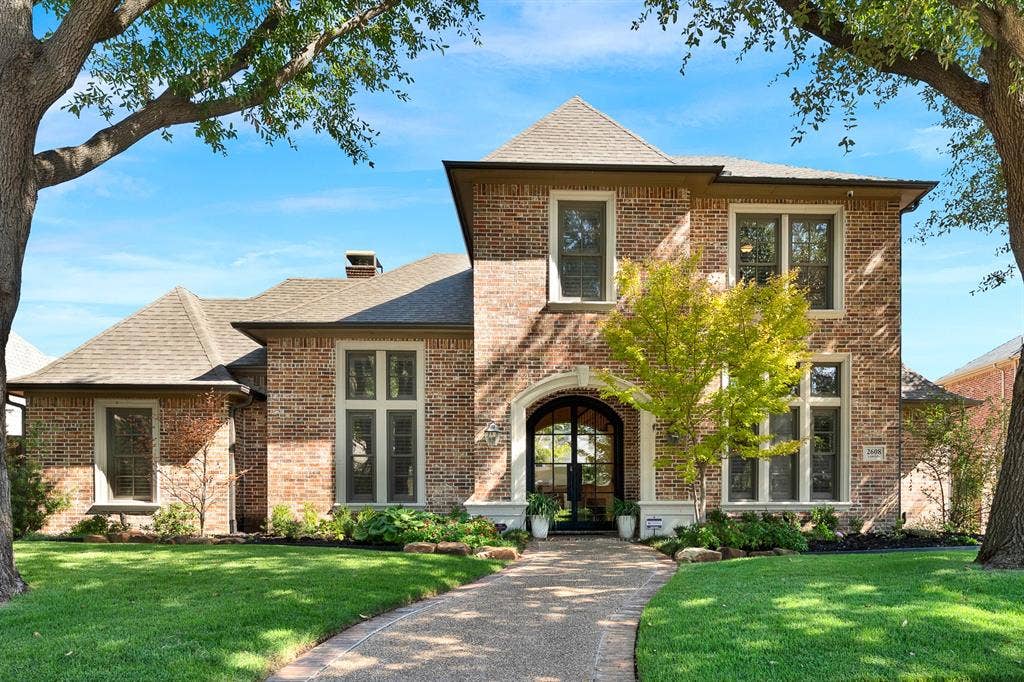 2608 LAWTON Lane, Plano, TX 75093 Welcome to 2608 Lawton in Plano. A grand arched entryway framed in stone accents sets a welcoming tone against a timeless multi-tone brick facade. Imagine strolling down the curved front pathway on a sunny afternoon as dappled light filters through mature shade trees.