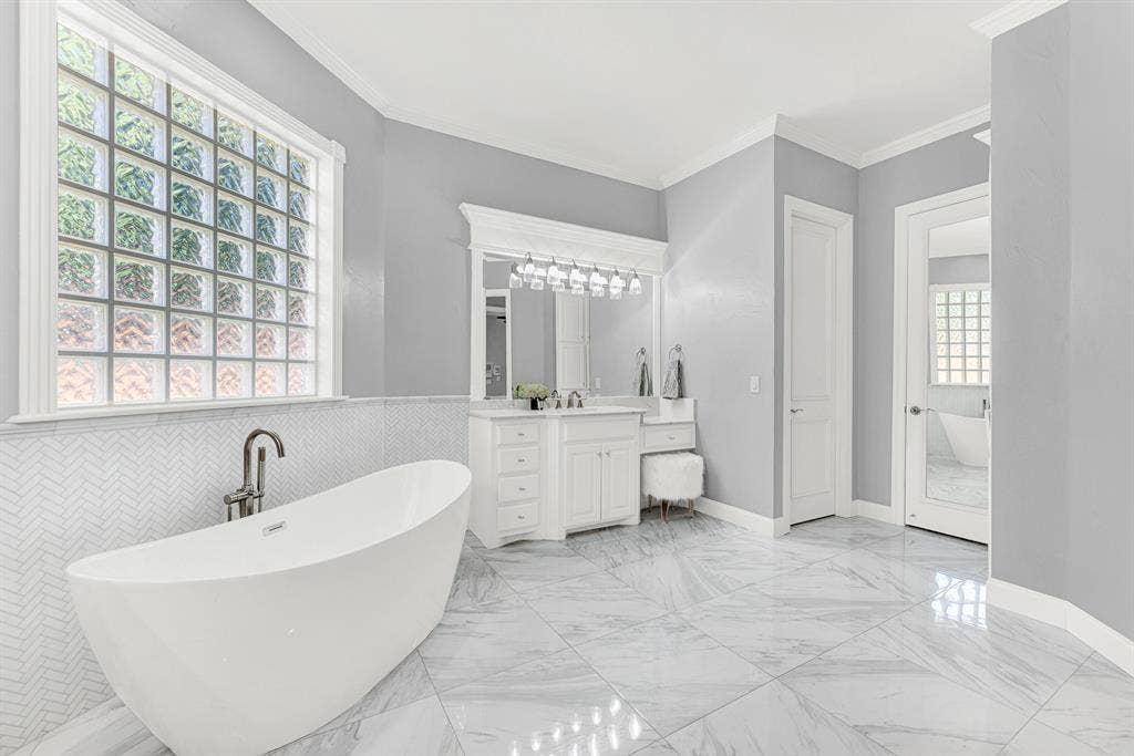 2608 LAWTON Lane, Plano, TX 75093 Custom built-in vanities include a lowered makeup station, highlighted by crisp trim detailing and large lighted mirrors. It is a serene environment to get ready effortlessly each morning surrounded by organized luxury.
