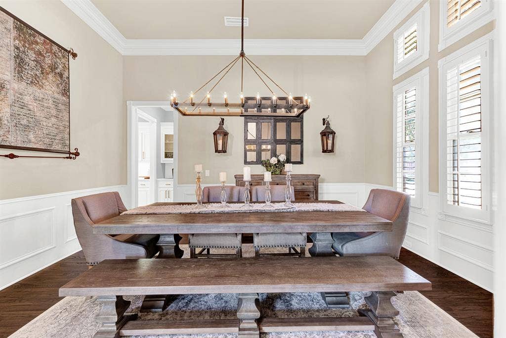 2608 LAWTON Lane, Plano, TX 75093 Refined wainscoting and classical crown molding wrap the perimeter, balancing structured design with ambient overhead glow. Picture gathering your favorite people around the table for an intimate dinner party that lingers long into the evening.