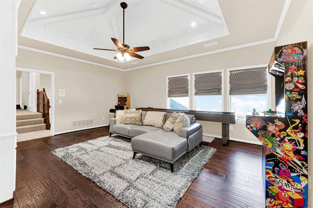 2608 LAWTON Lane, Plano, TX 75093 Triple windows framed with woven shades offer peaceful treetop views alongside the rich wood flooring. Imagine spending a cozy rainy afternoon kicking back and enjoying friendly arcade competitions.