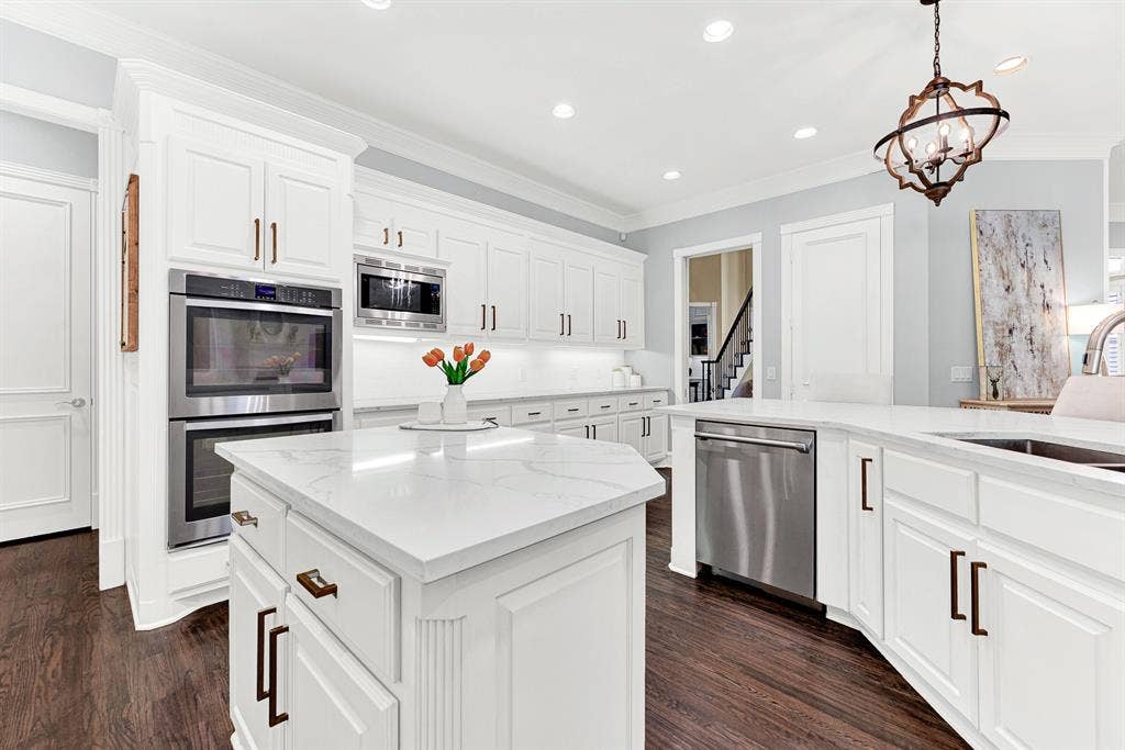 2608 LAWTON Lane, Plano, TX 75093 Double walk-in pantry doors integrated into crisp millwork maximize organization alongside high-end stainless appliances. You can easily unpack groceries and stock shelves with ease after a quick afternoon shopping trip.