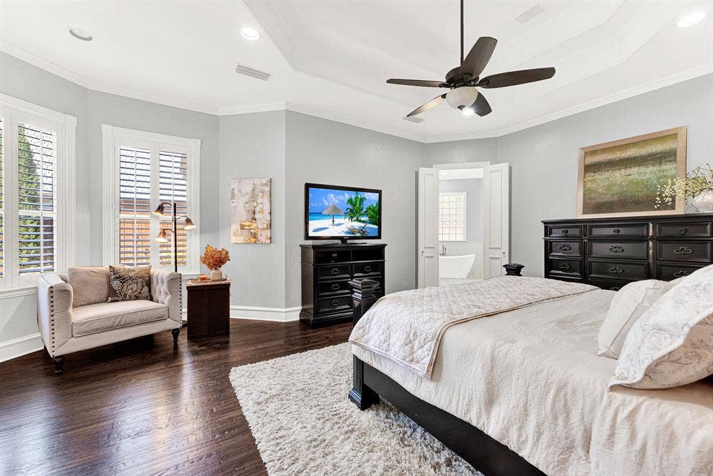 2608 LAWTON Lane, Plano, TX 75093 Tall shuttered windows tuck neatly into a angled bay wall, drawing soft natural light across the spacious bedroom layout. It is an ideal nook to curl up with a good book and a warm cup of morning tea.