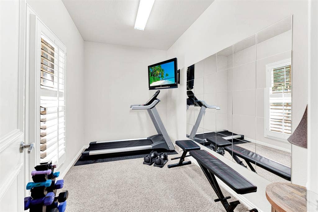 2608 LAWTON Lane, Plano, TX 75093 A full-height mirrored accent wall doubles the light and sense of space across neat plush carpeting. It is the ideal private nook to squeeze in a energizing morning workout before starting your daily routine.
