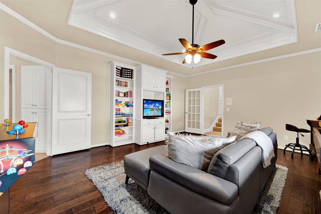 2608 LAWTON Lane, Plano, TX 75093 Custom built-in display shelves and French doors establish clean architectural organization within this versatile upper floor retreat. You can easily grab your favorite board games from the built-in storage for a relaxing weekend lounge with family.