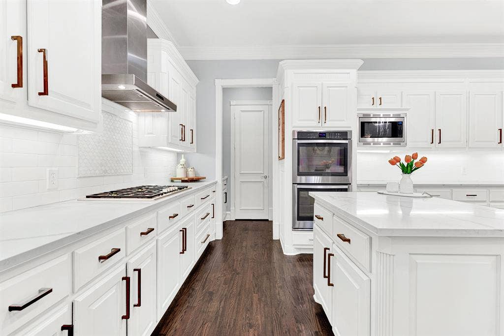 2608 LAWTON Lane, Plano, TX 75093 Built-in double ovens and deep storage drawers align along immaculate tiled backsplashes for sleek functionality. Picture baking holiday treats together as delicious scents fill every corner of your bright, airy home.