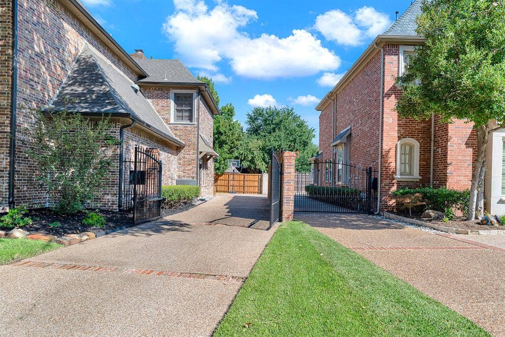 2608 LAWTON Lane, Plano, TX 75093 A black automatic metal gate provides access to the driveway, which leads to a large A black metal automatic gate provides access to the driveway, which leads to a double large parking area. Great for all kinds of activities.