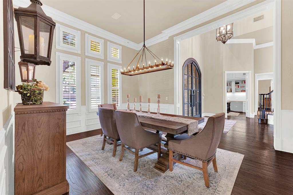 2608 LAWTON Lane, Plano, TX 75093 Soaring open archways integrate the dining space seamlessly with the surrounding foyer and dark wood flooring. You will love serving a festively prepped weekend brunch as natural sunlight pours through the shuttered windows.