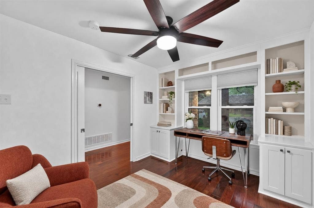 12627 Breckenridge Drive, #200, Dallas, TX 75230 Custom built-in white cabinetry with integrated shelving, dark wood-finish flooring, and a multi-blade ceiling fan with central illumination