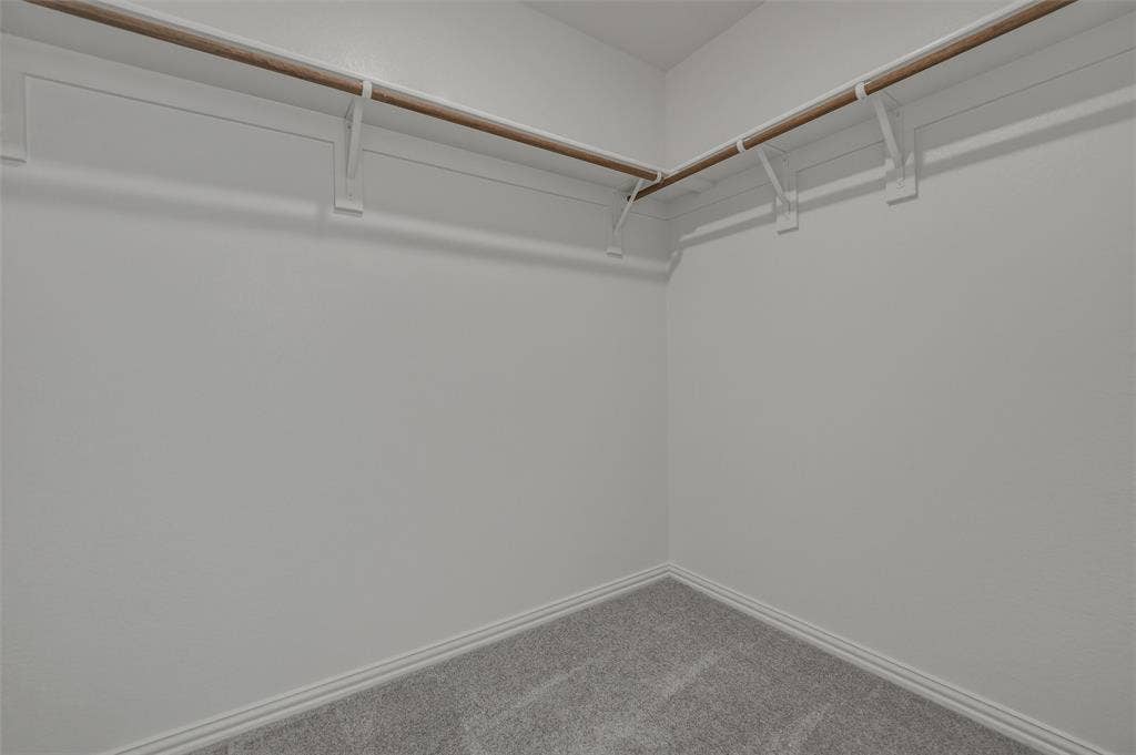 2109 Bluebird Lane, Anna, TX 75409 Corner closet featuring light gray carpeting and white walls