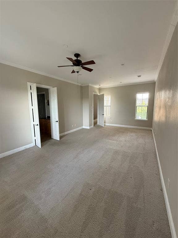 1025 Emerson Park Lane, Irving, TX 75063 Room featuring neutral wall tones, crown molding, wall-to-wall carpeting, a ceiling fan with integrated lighting, and French doors