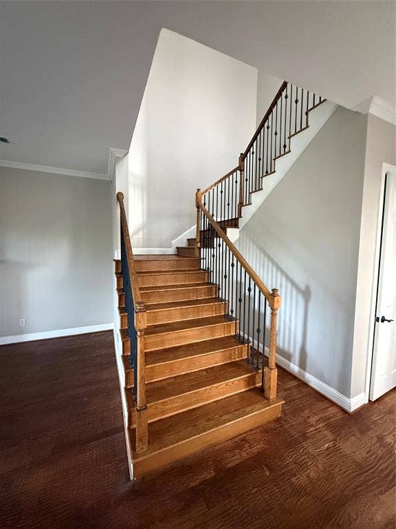 1025 Emerson Park Lane, Irving, TX 75063 Staircase featuring wood-finish treads, square newel posts, and decorative metal balusters set against wood-finish flooring
