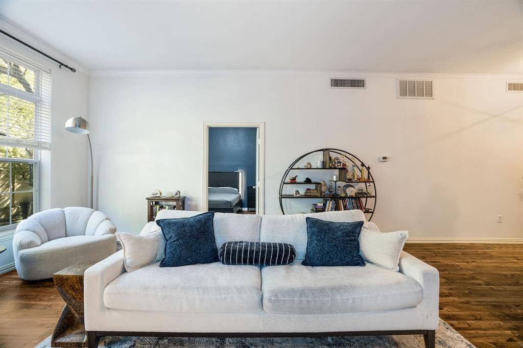 2305 Worthington Street, #103, Dallas, TX 75204 Expansive living area featuring tall windows, wood-finish flooring, and crown molding