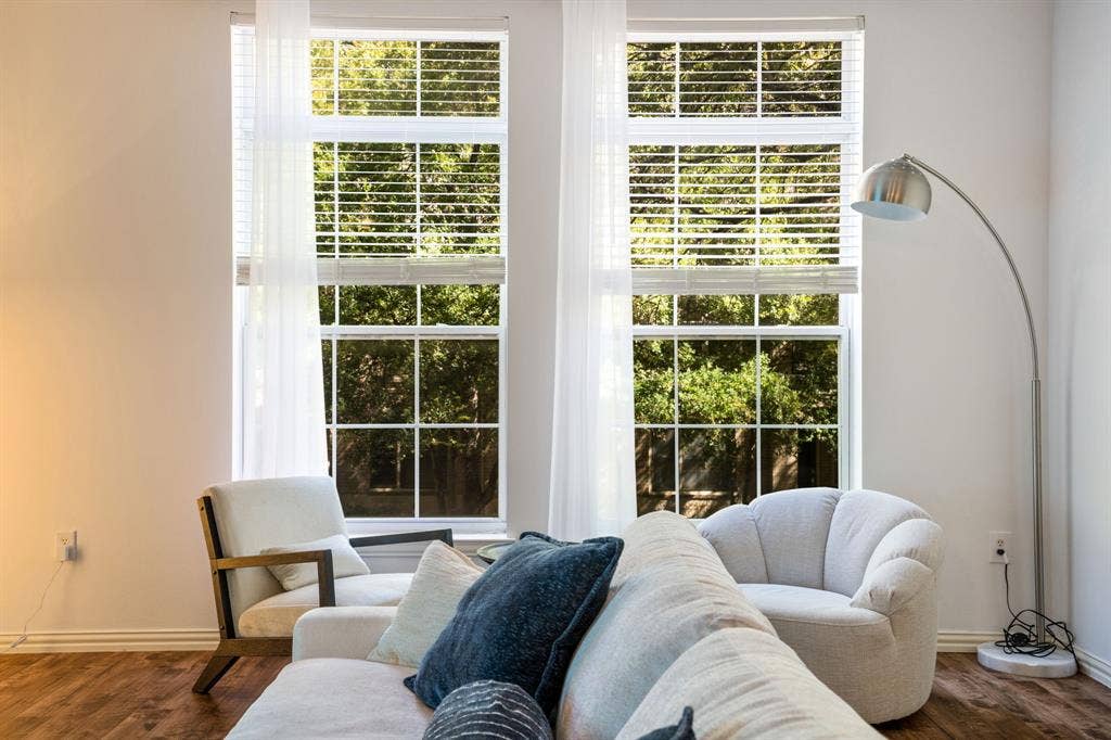 2305 Worthington Street, #103, Dallas, TX 75204 Dual floor-to-ceiling windows with mullion detailing, horizontal blinds, and wood-finish flooring