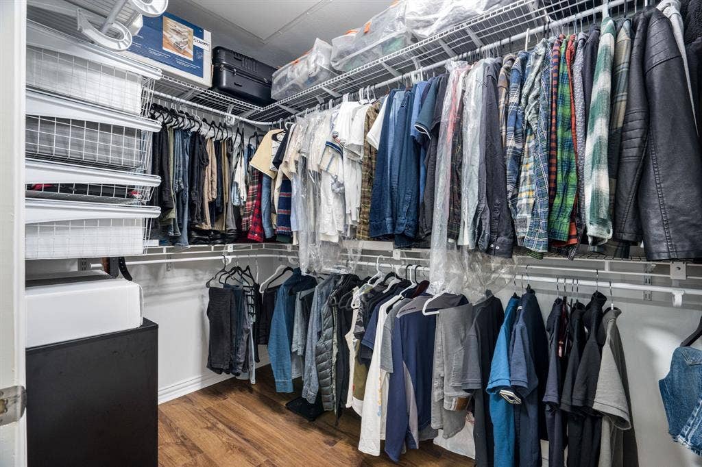 2305 Worthington Street, #103, Dallas, TX 75204 Walk-in storage area featuring multi-tiered white wire shelving, overhead storage racks, and wood-finish flooring