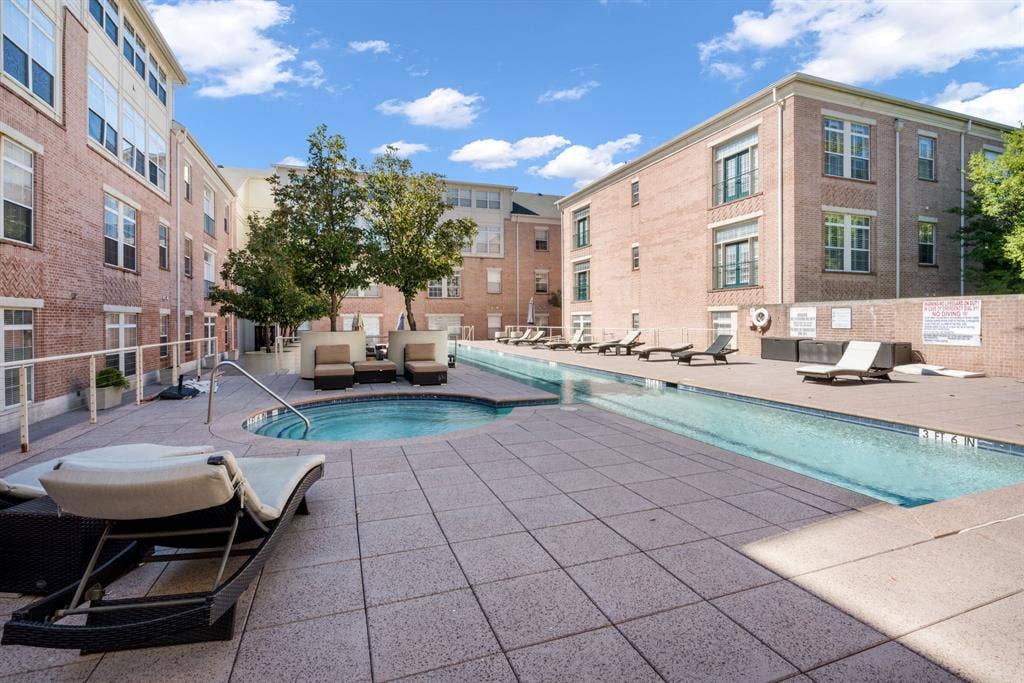 2305 Worthington Street, #103, Dallas, TX 75204 Swimming pool and attached spa area with paved deck, surrounded by brick building exteriors