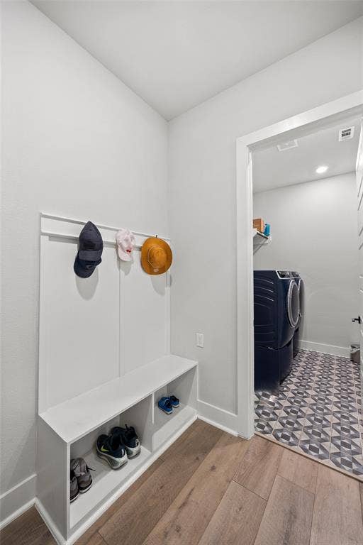 2820 Eccleston Street, Celina, TX 75009 Built-in white mudroom bench featuring integrated shelving and wall-mounted coat hooks, wood-finish flooring, and patterned tile flooring