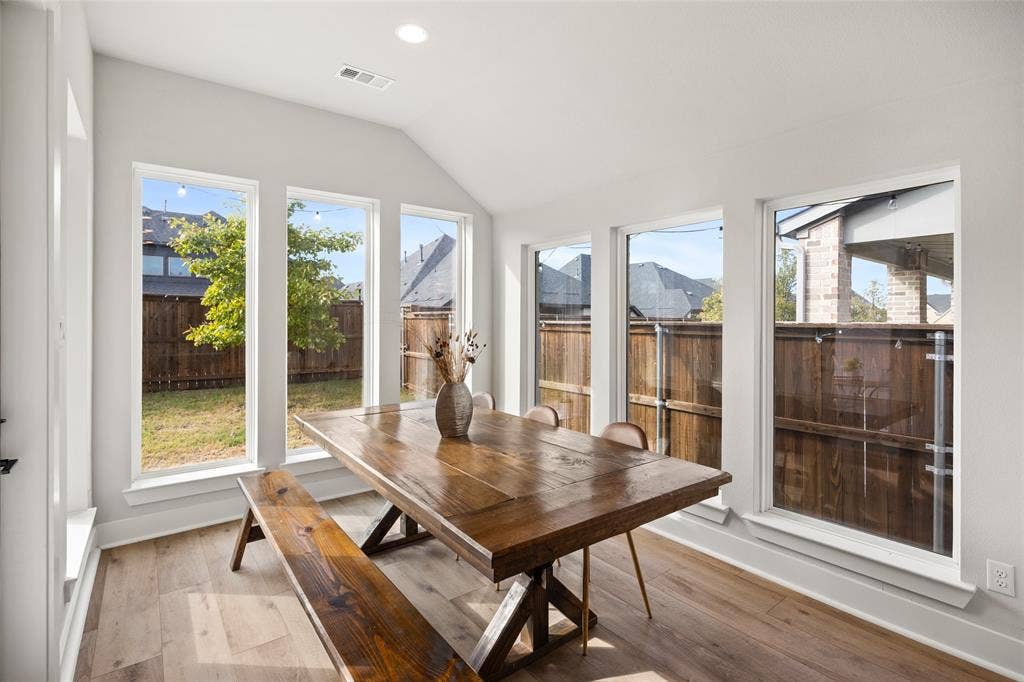 2820 Eccleston Street, Celina, TX 75009 Sunroom featuring a vaulted ceiling, wood-finish flooring, and five expansive windows