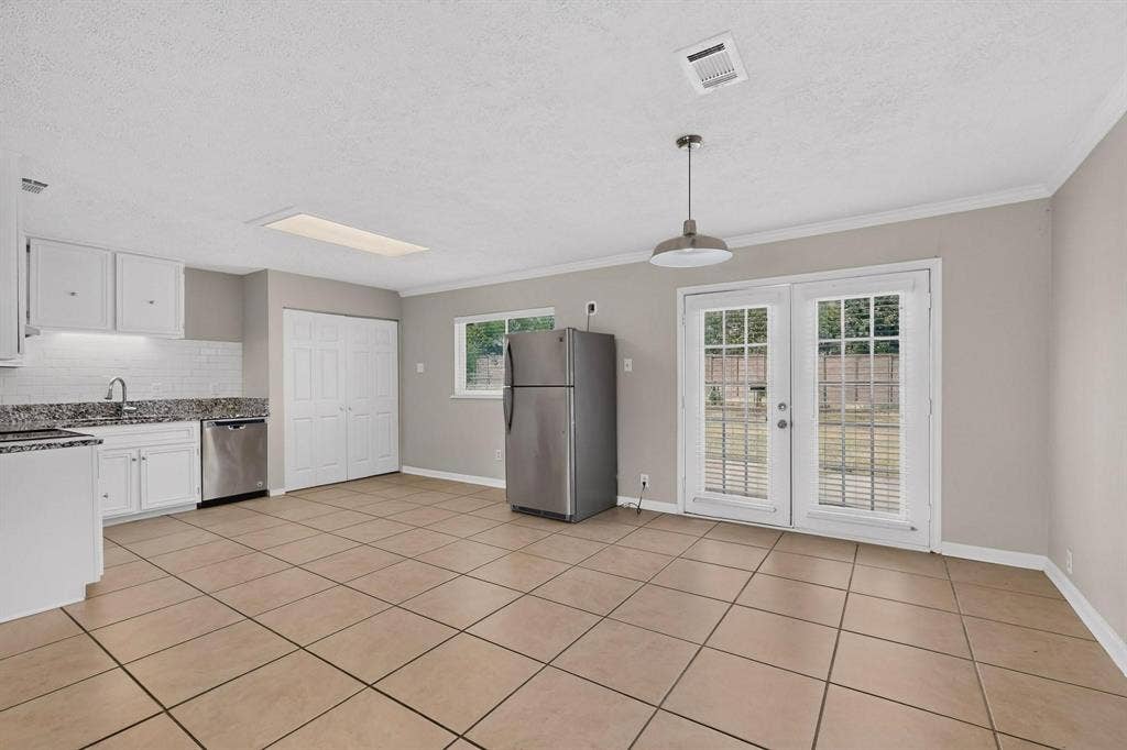 501 Starling Drive, Mesquite, TX 75149 Bright dining area beside a framed glass door to the backyard, enhancing the openness and airy atmosphere.