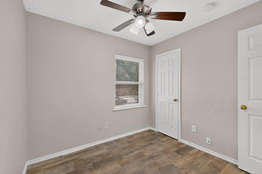 501 Starling Drive, Mesquite, TX 75149 A well-lit second bedroom featuring a ceiling fan, closet and a window that invites sunlight in.