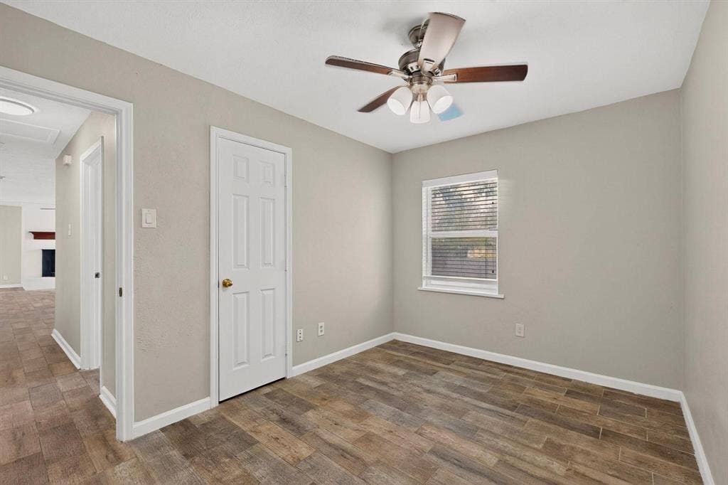 501 Starling Drive, Mesquite, TX 75149 A well-lit third bedroom featuring a ceiling fan, closet and a window letting in natural light.