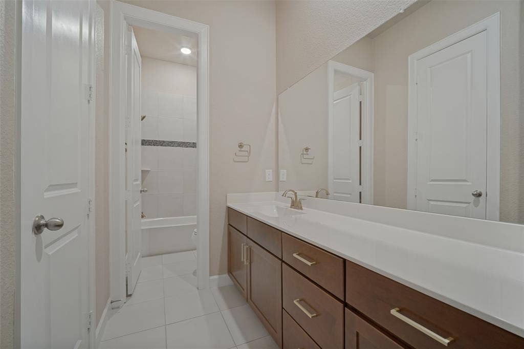 Guest bathroom with large prep area separated by the toilet and shower