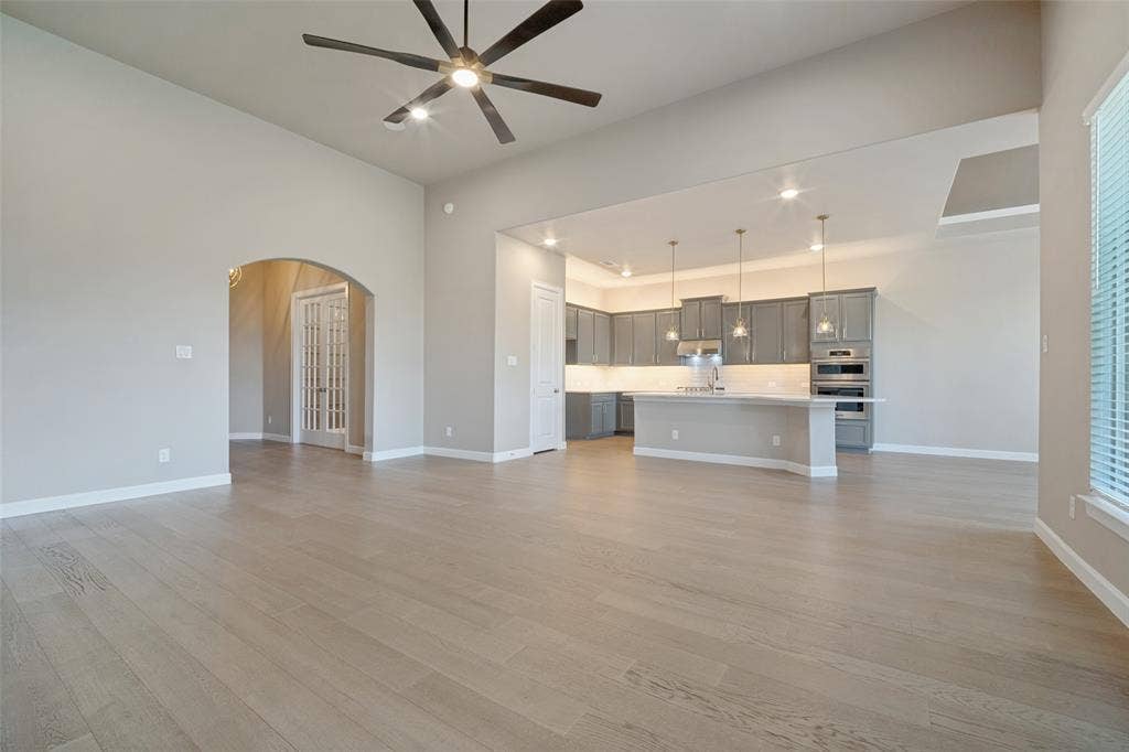 Open living and dining room space with stunning light wood-look flooring seamlessly blending the spaces together