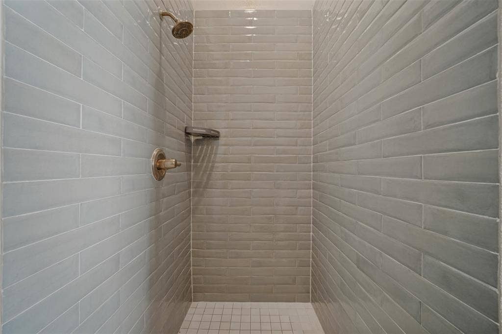 En suite primary bathroom with dual sinks, a separate soaker tub and walk in shower